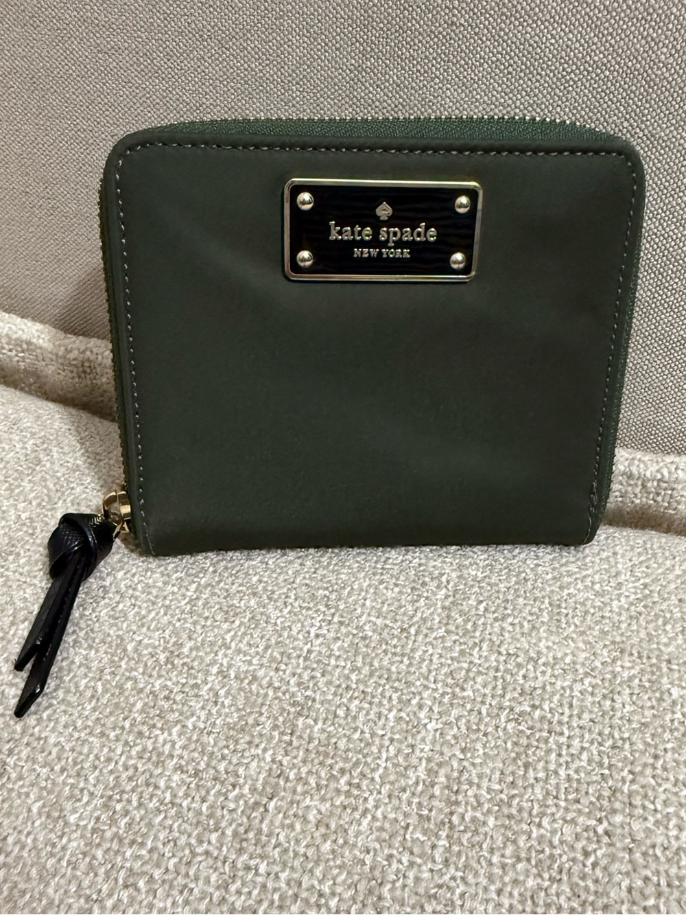 kate spade olive green zip-around wallet with gold plaque